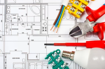 Graphic of Electrical tools and supplies—including wire strippers, screwdrivers, terminal blocks, exposed electrical wires, and a light bulb—laid out on top of a detailed residential floor plan with room labels and measurements.